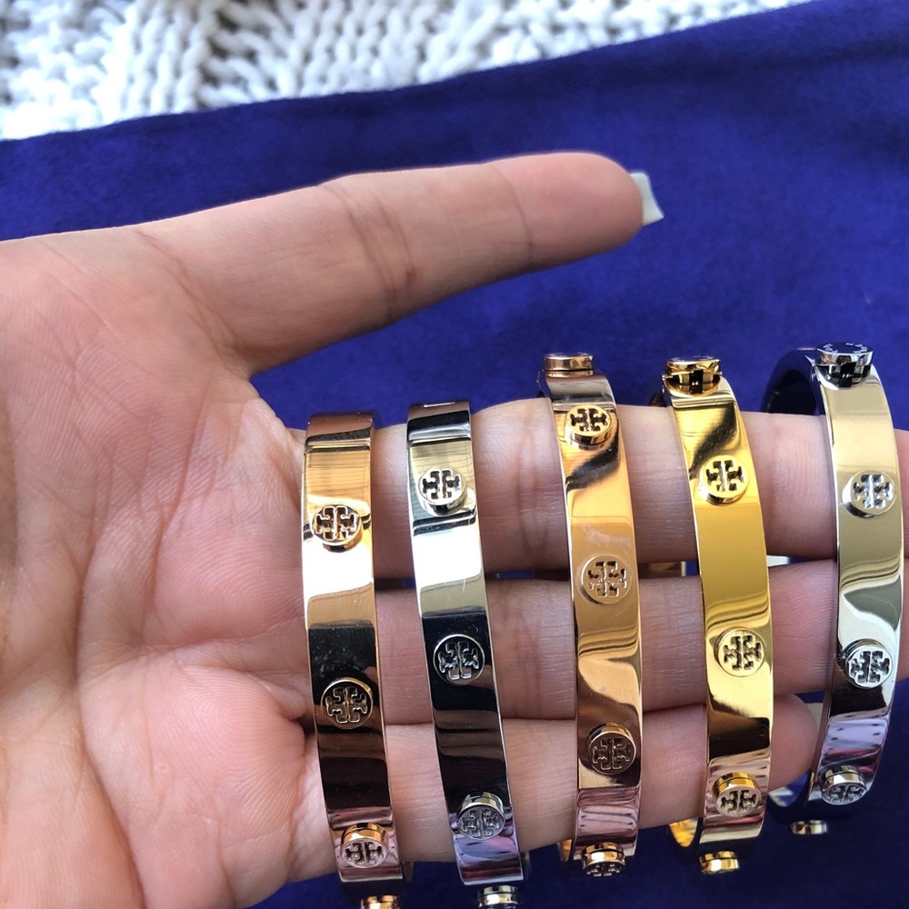 Two Tory Burch Gold Logo Bracelets